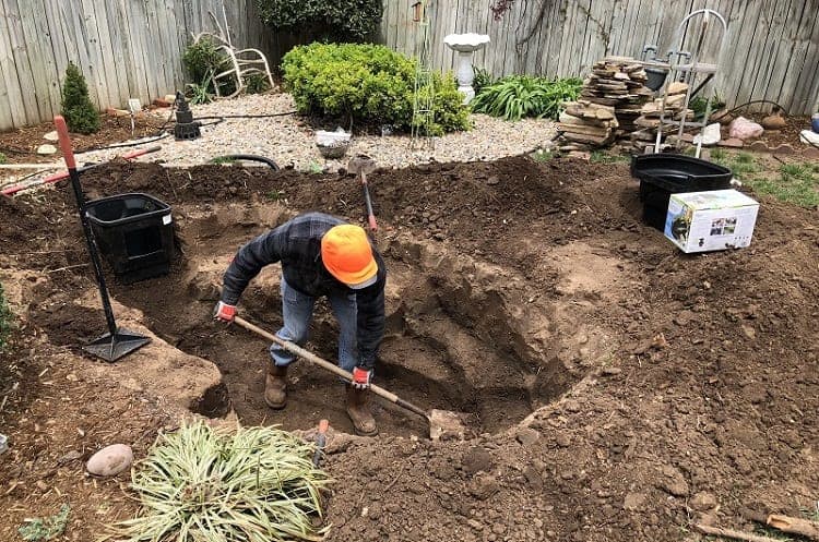 Man Digging Hole For Garden Pond